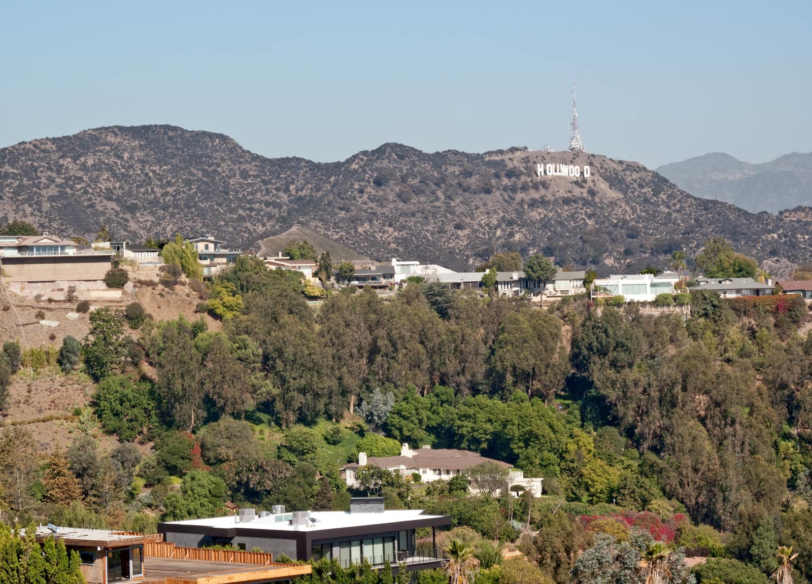 The Hollywood Sign on Mount Lee seen across canyon homes from the Runyon Canyon trail