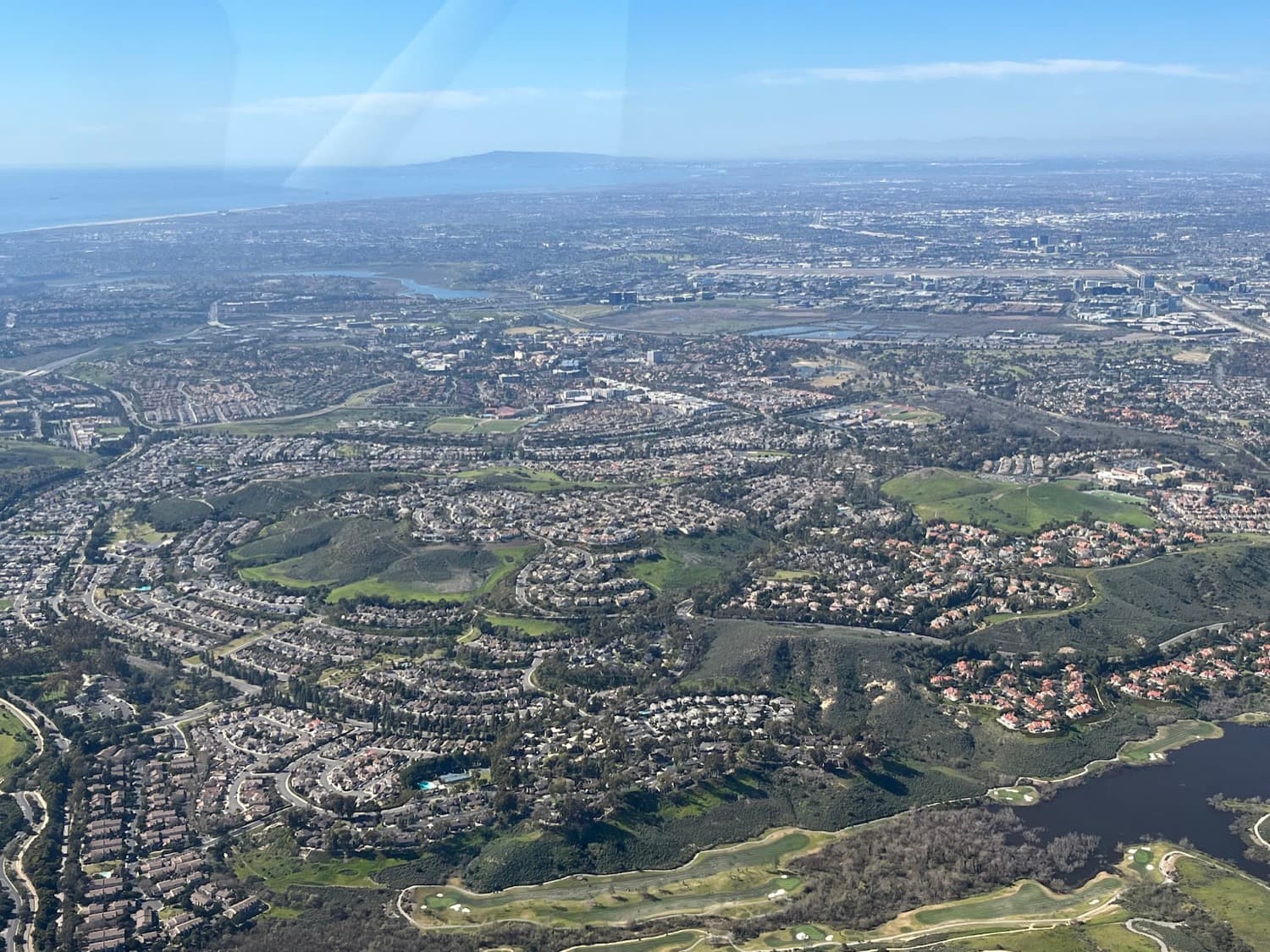 Aerial view of the Turtle Rock hillside neighborhoods above Irvine toward the coast