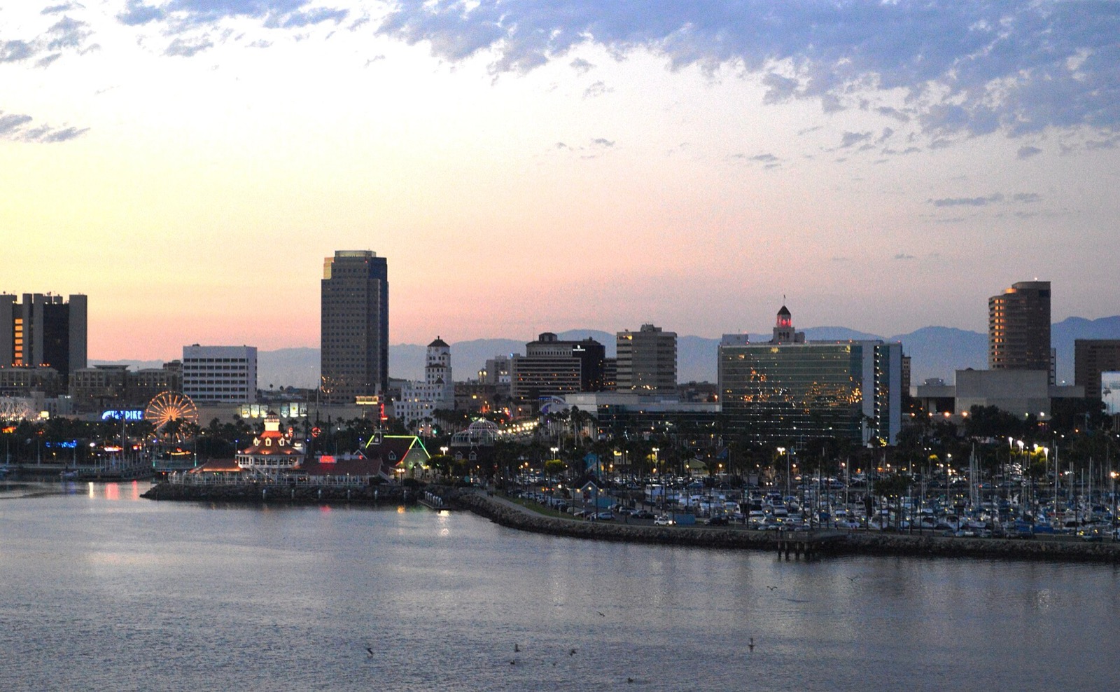 Downtown Long Beach skyline at dusk seen across the harbor from the Queen Mary