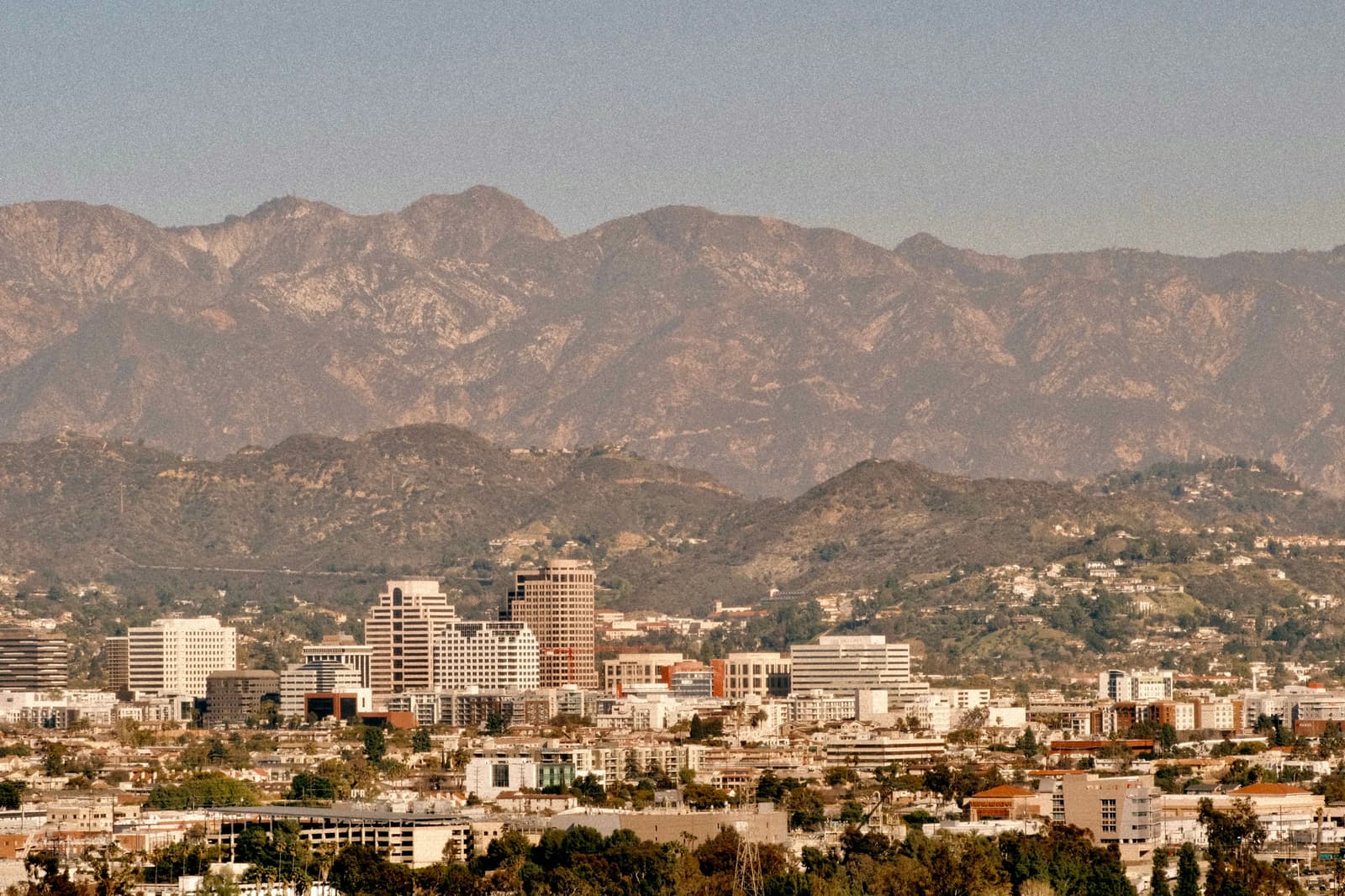 Downtown Glendale in warm evening haze with the Verdugo Mountains rising behind it